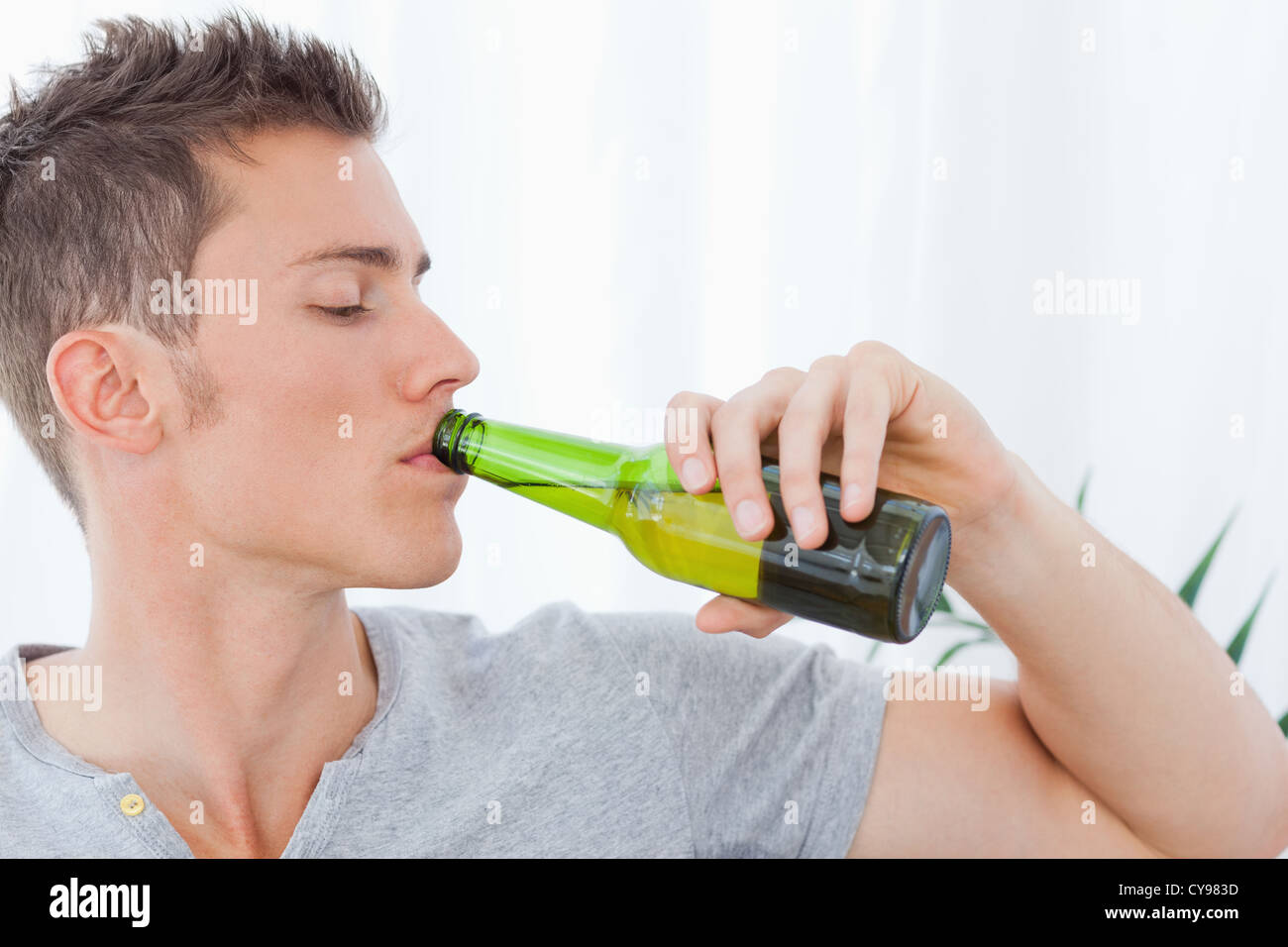 a-handsome-man-drinking-some-beer-CY983D.jpg