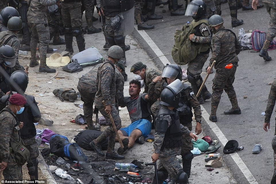 38123118-9157237-A_Honduran_migrant_is_tended_to_by_Guatemalan_soldiers_after_the-a-8_1610924367846.jpg